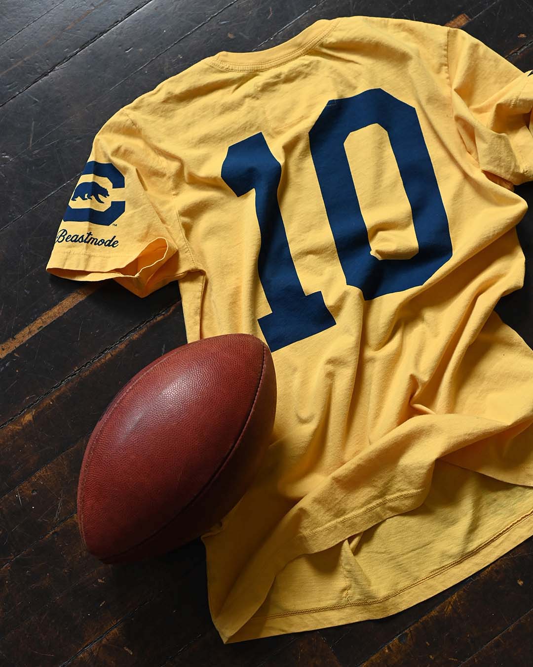 CAL - Marshawn Lynch #10 Gold Tee - Roots of Fight