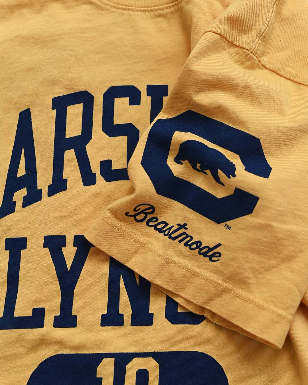 CAL - Marshawn Lynch #10 Gold Tee - Roots of Fight