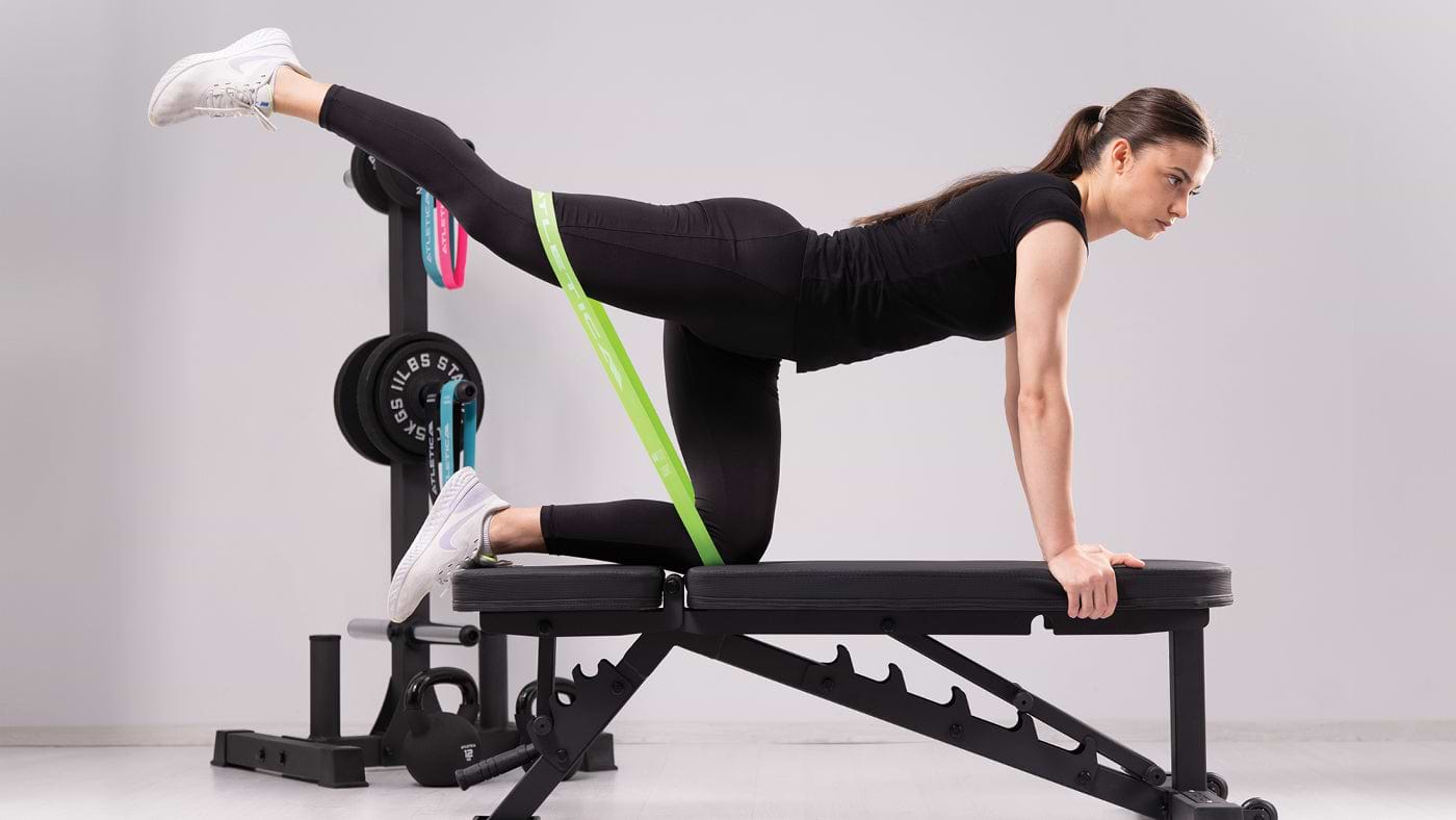 Leg raises with resistance band on weight bench