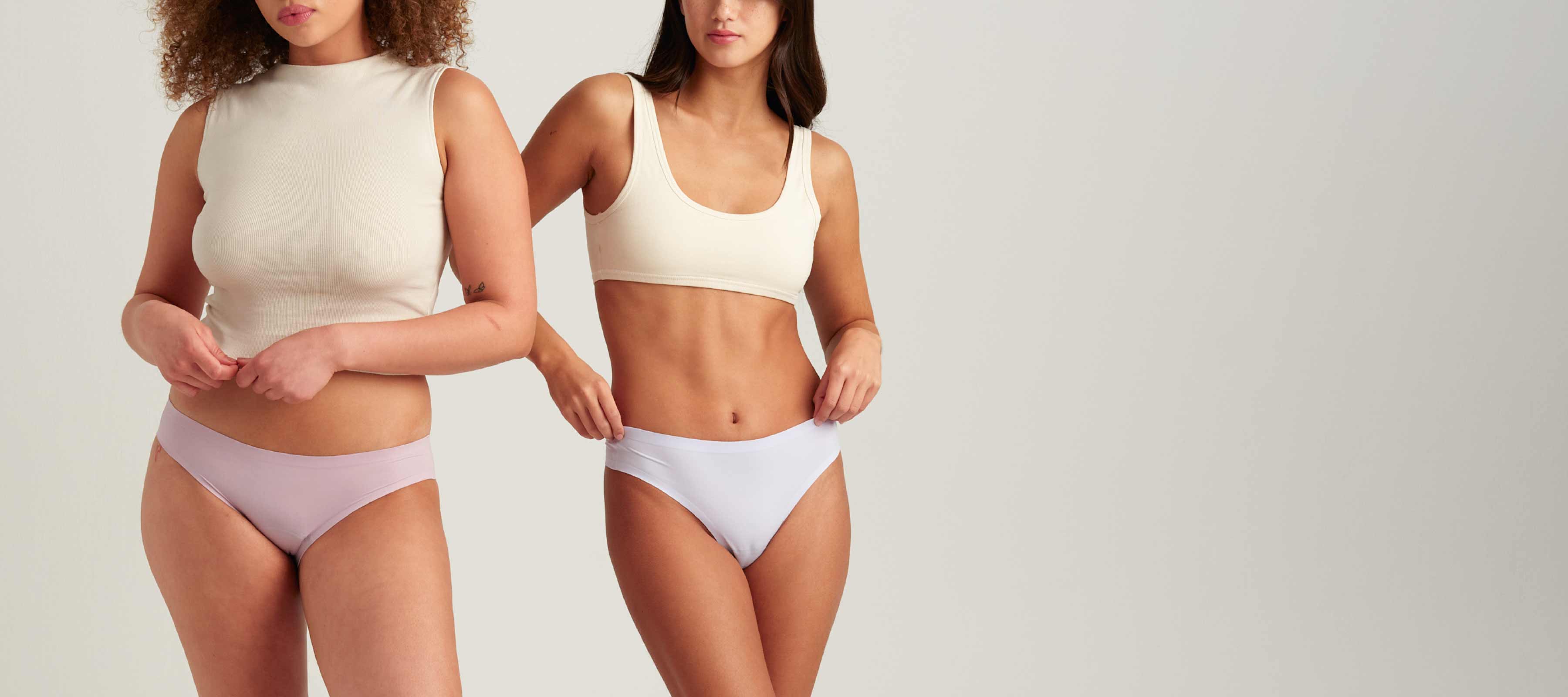 Two models wearing Saalt Wear. One in Leakproof Seamless Bikini Sunset Mauve, the other in Leakproof Seamless Thong Soft Lavender.