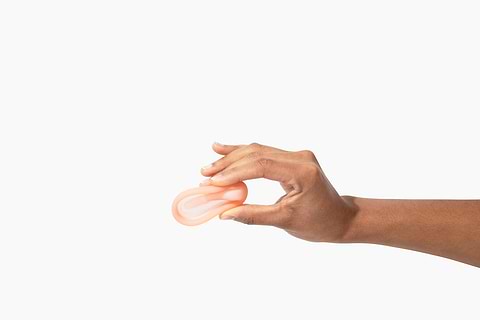Hand holding a menstrual disc