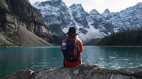 Backpacker sitting at lake
