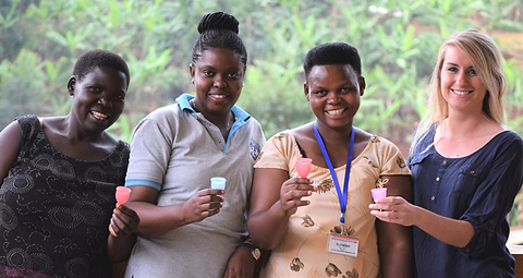 Women holding pink menstrual cups