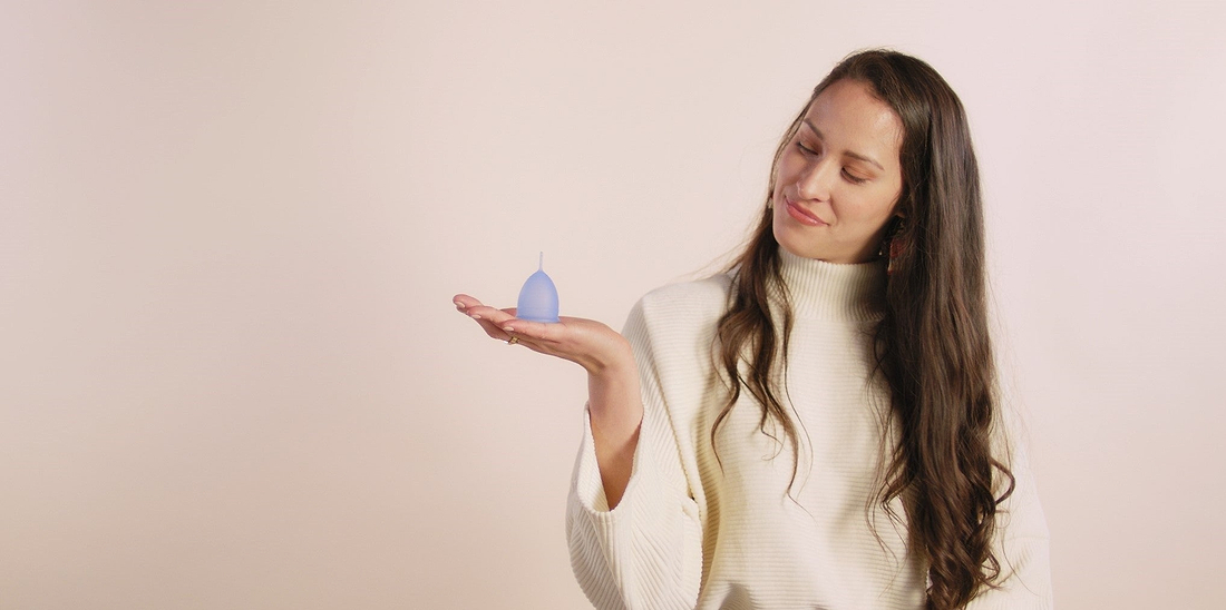 Woman holding a menstrual cup