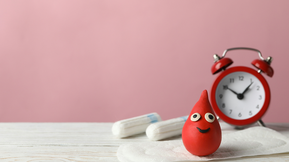 Red Alarm Clock Behind Period Products and Clay-shaped Blood Drop