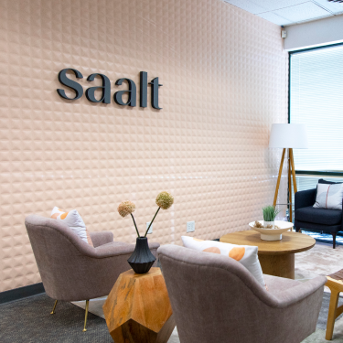 black saalt lettering on a gold textured wall