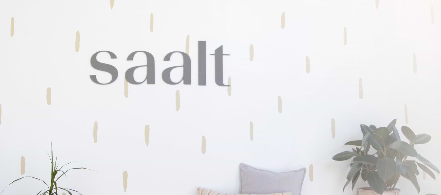 Saalt black lettering on white and gold wall