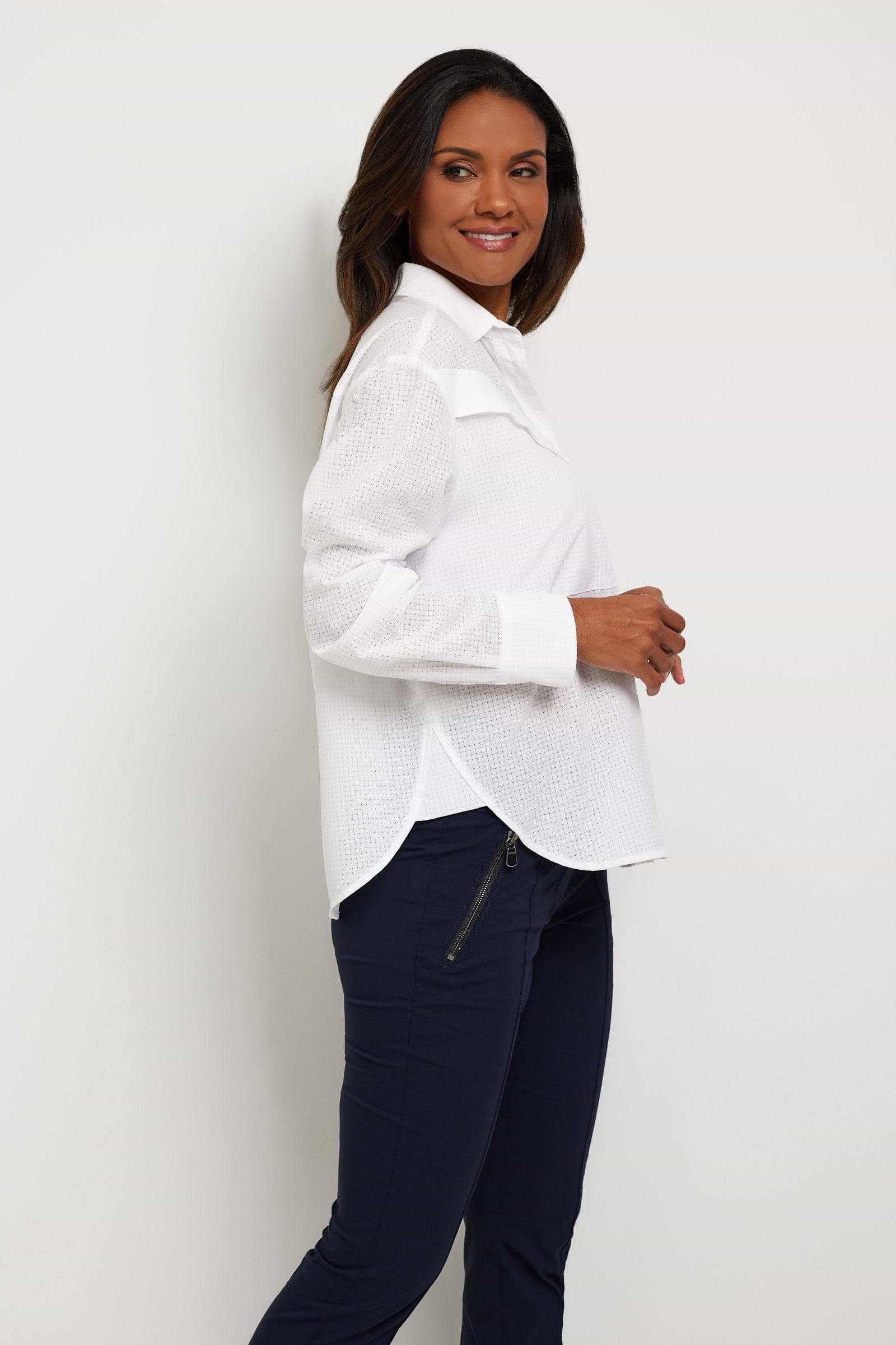 The Best Travel Top. Woman Showing the Side Profile of a Kieran Top in White.
