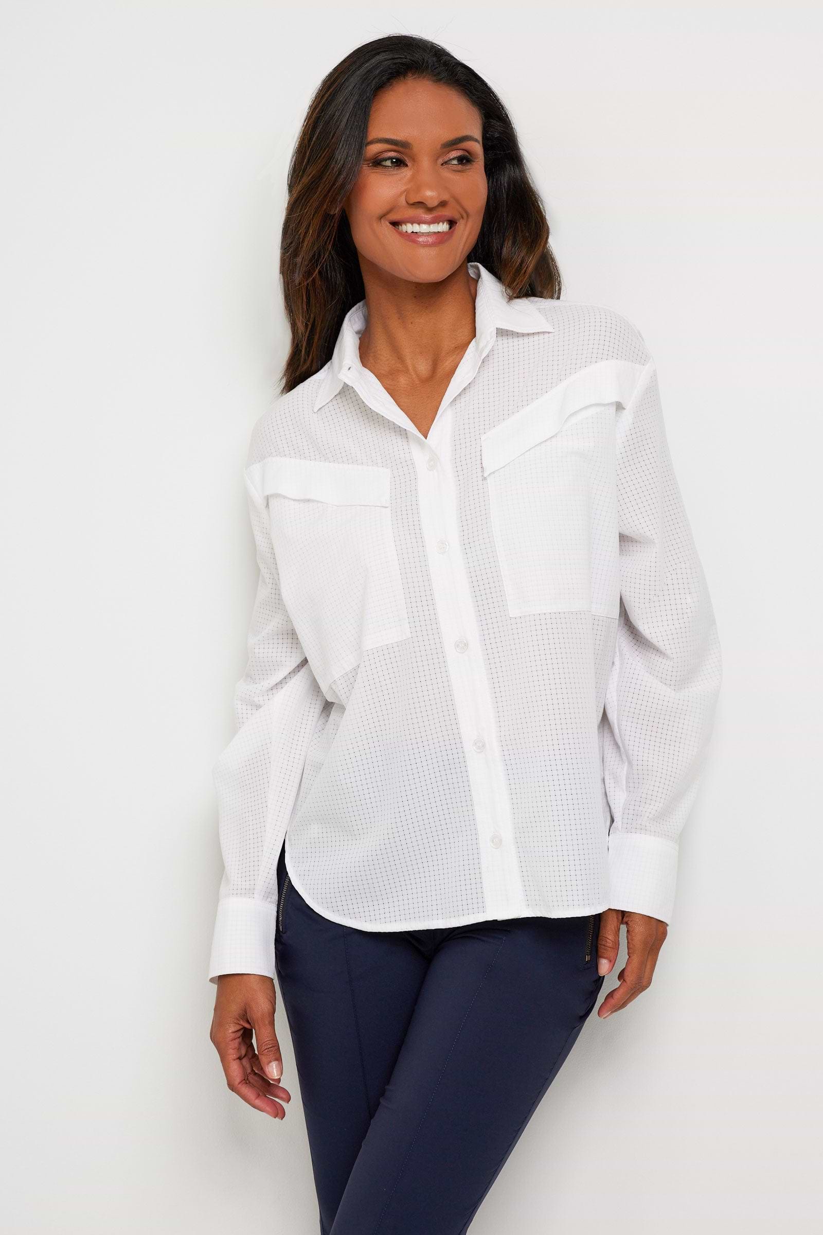 The Best Travel Top. Woman Showing the Front Profile of a Kieran Top in White.