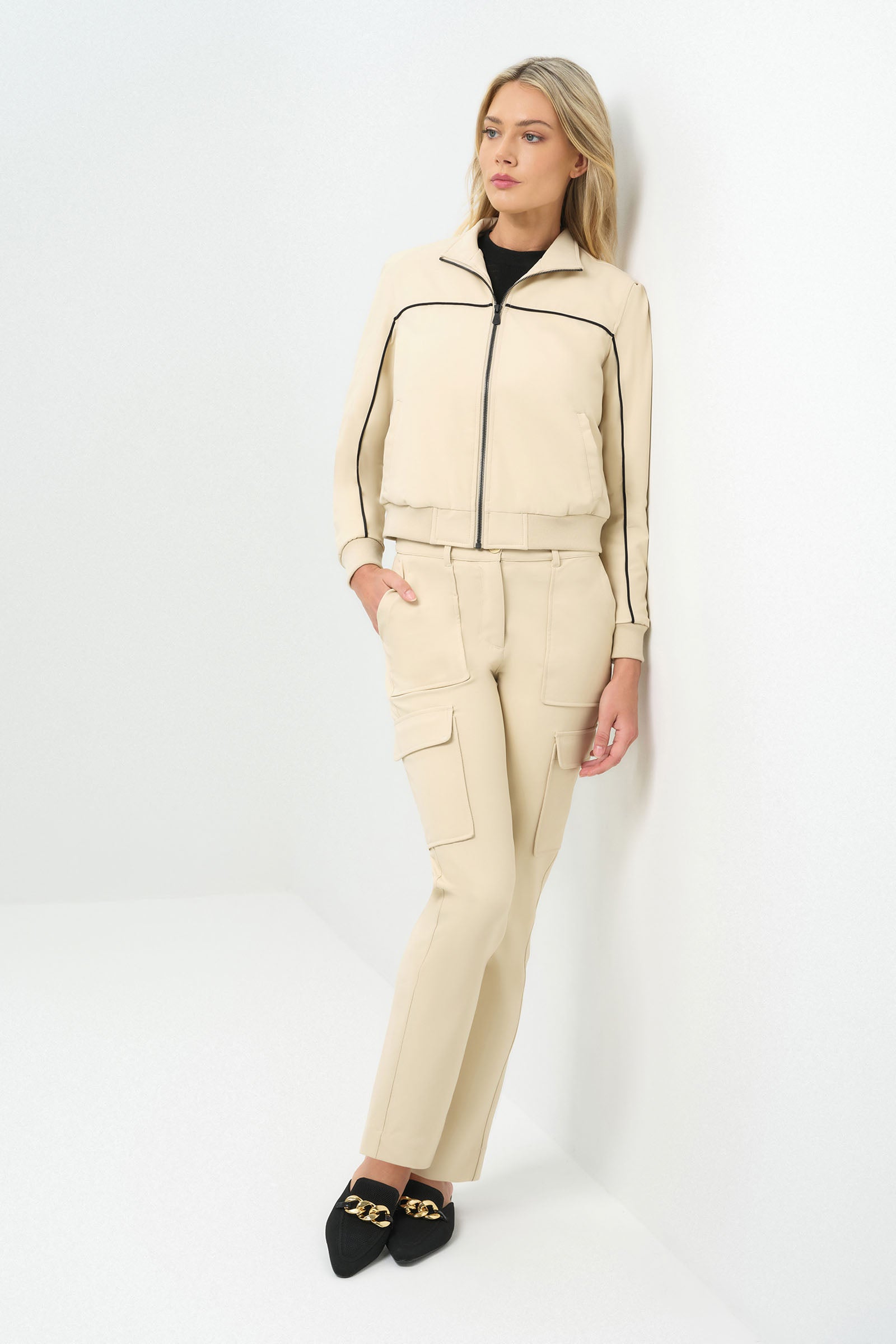 Full body view of cream bomber jacket zipped up with matching cargo patch pocket pant