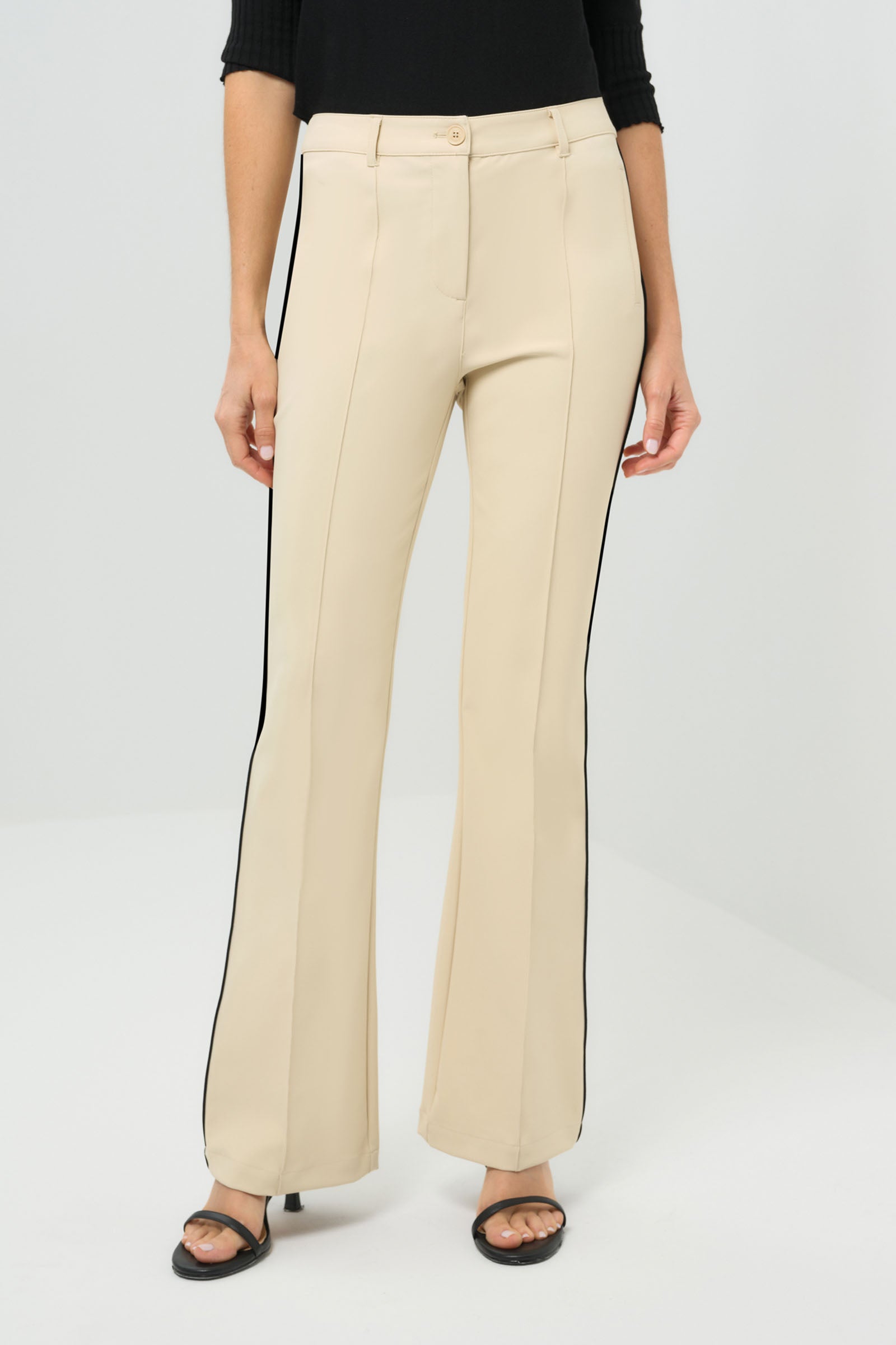 Close-up view of wheat pants with a black stripe on the side.
