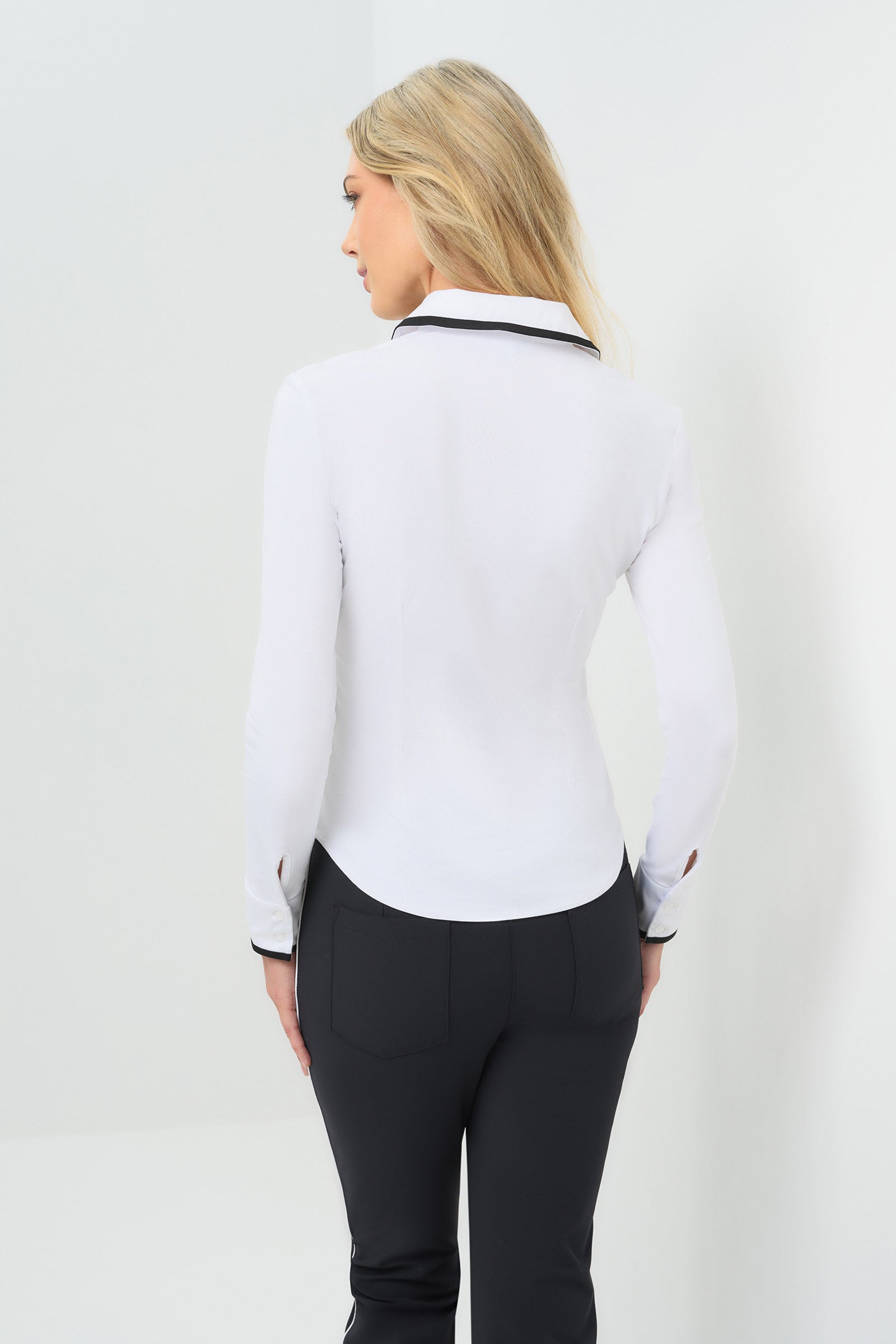 Back view white long-sleeve zip-front blouse featuring a contrasting black trim along the collar, zipper placket, and cuffs.