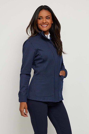 The Best Travel Jacket. Woman Showing the Side Profile of an Lucia Jacket in Navy/White.