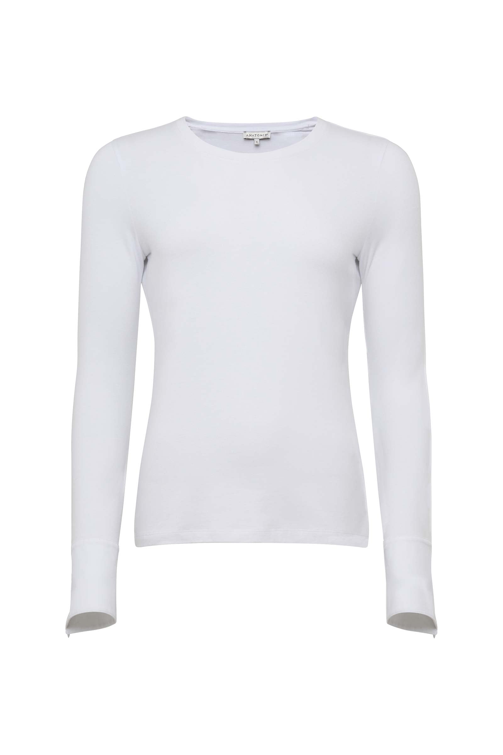 Close-up flat lay of the white Mayven Crewneck Top's contrast color button and tailored cuff detail.