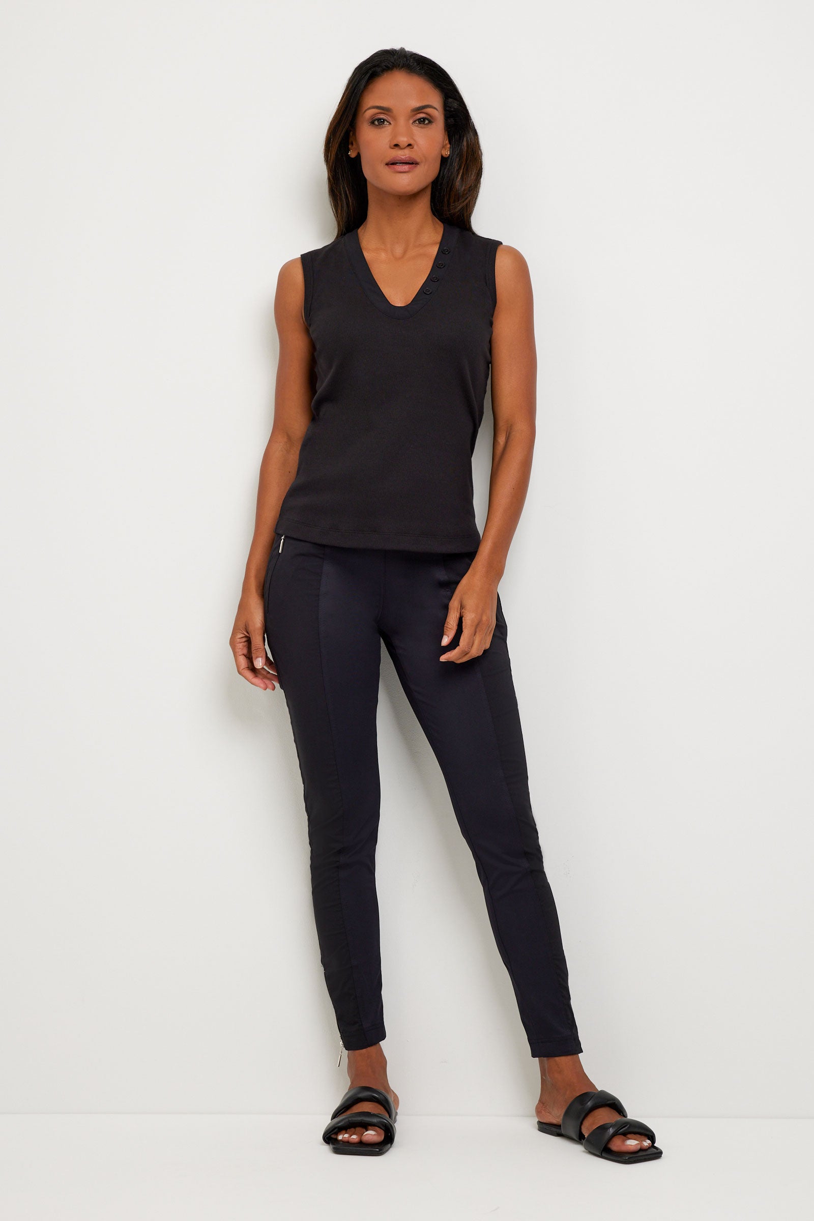 The Best Travel Top. Woman Showing the Front Profile of a Madelyn Top in Black.