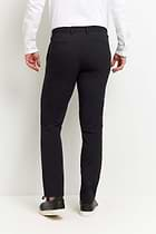 The Best Travel Pant. Man Showing the Back Profile of a Men's Stewart Pant in Black.