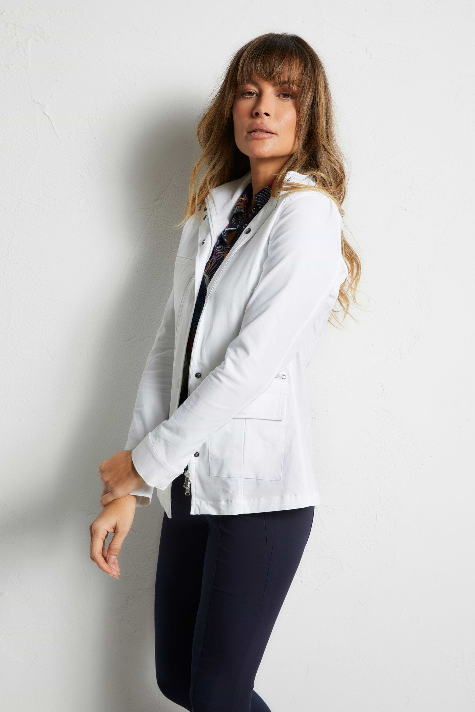 The Best Travel Safari Jacket. Woman Showing the Side Profile of a Safari Jacket in White ||