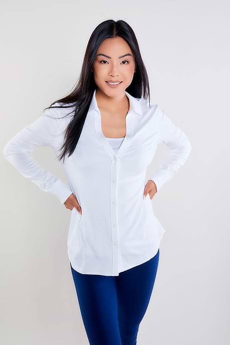 The Best Travel Shirt. Woman Showing the Front Profile of a Nikki Longsleeve Jersey Shirt in White