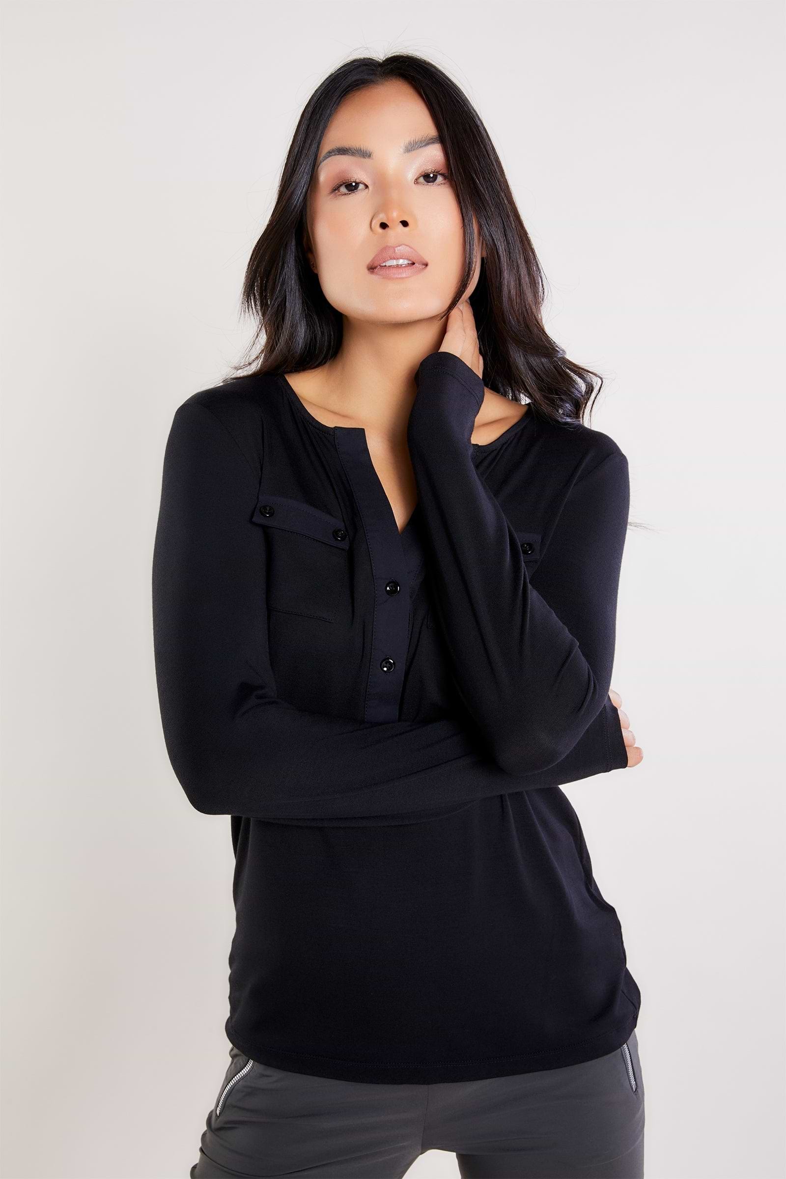The Best Travel Shirt. Woman Showing the Front Profile of a Calista Roll up Henley Top in Black