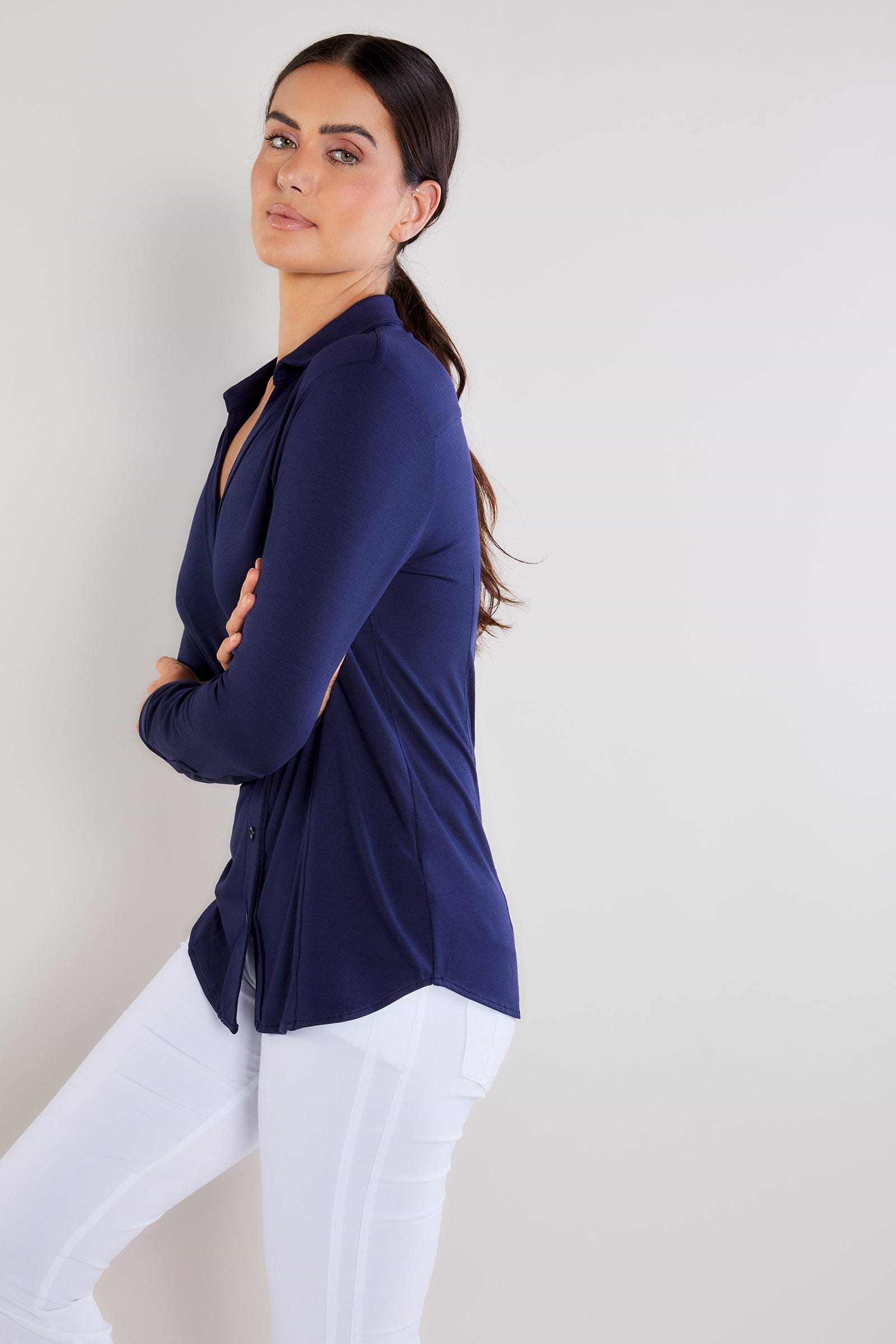 The Best Travel Shirt. Woman Showing the Side Profile of a Nikki Longsleeve Jersey Shirt in Navy