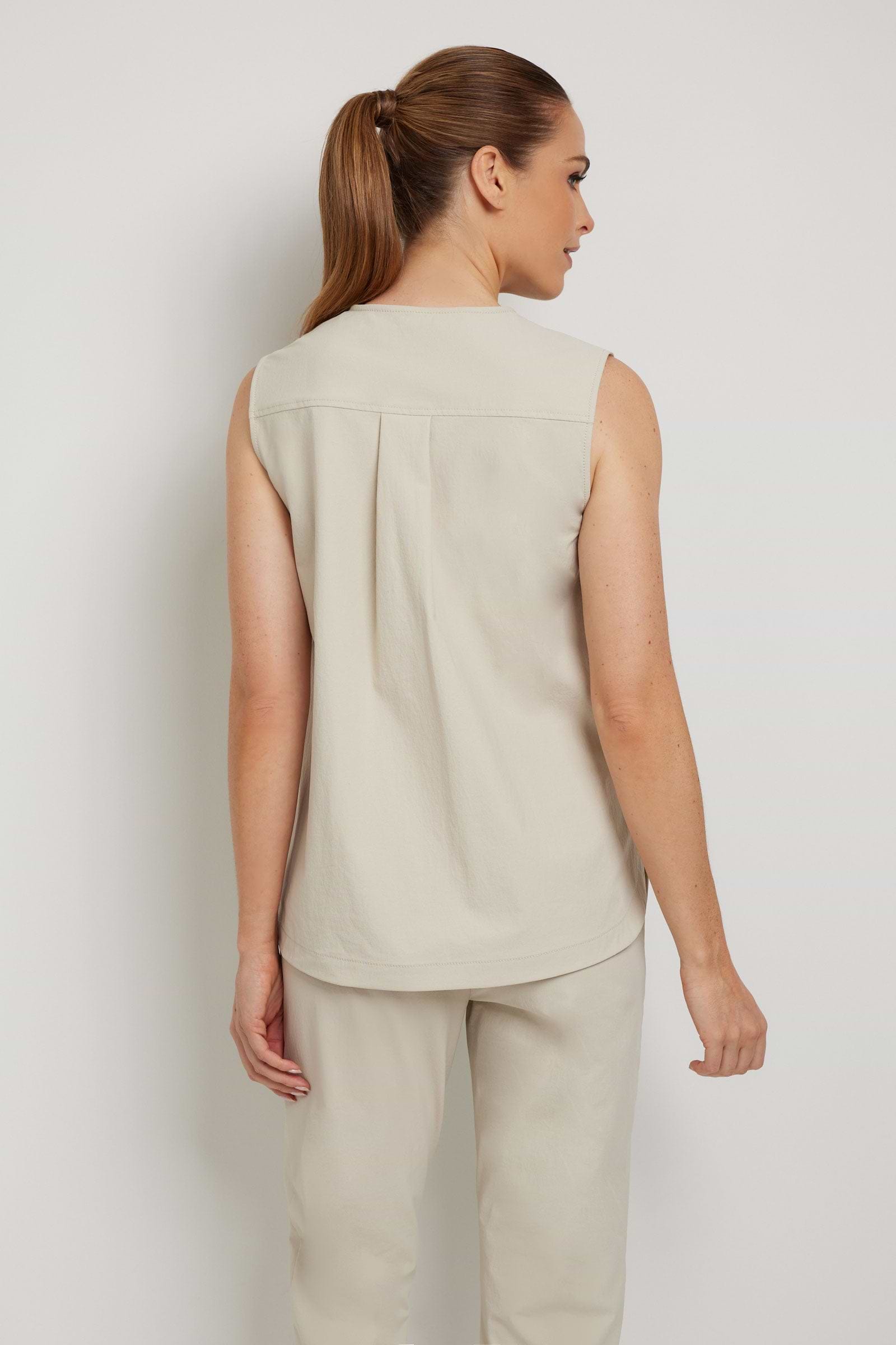 The Best Travel Top. Woman Showing the Back Profile of an Adley Top in Champagne.