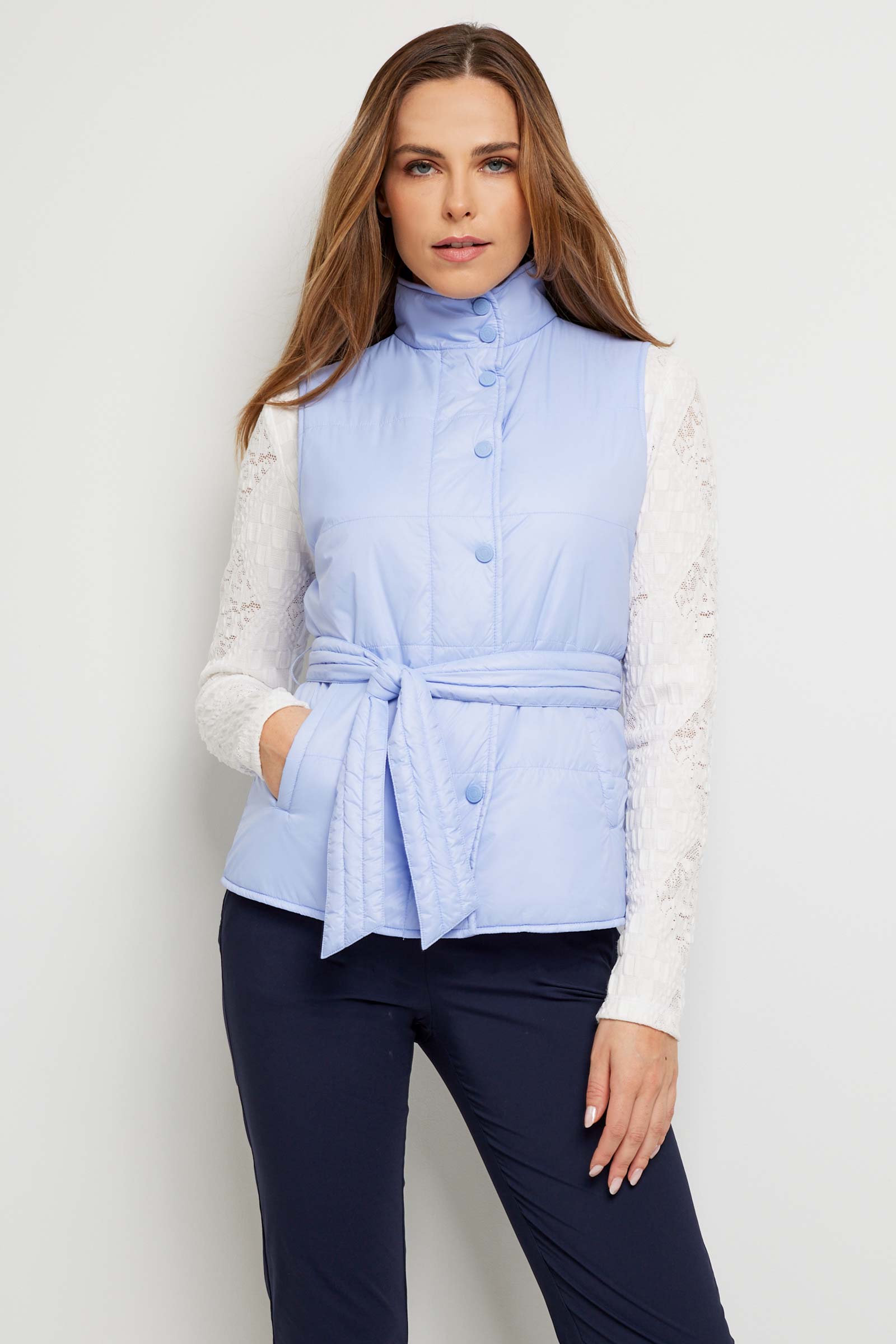 The Best Travel Vest. Woman Showing the Buttoned Up Front Profile of an Ainslee Quilted Vest in Periwinkle