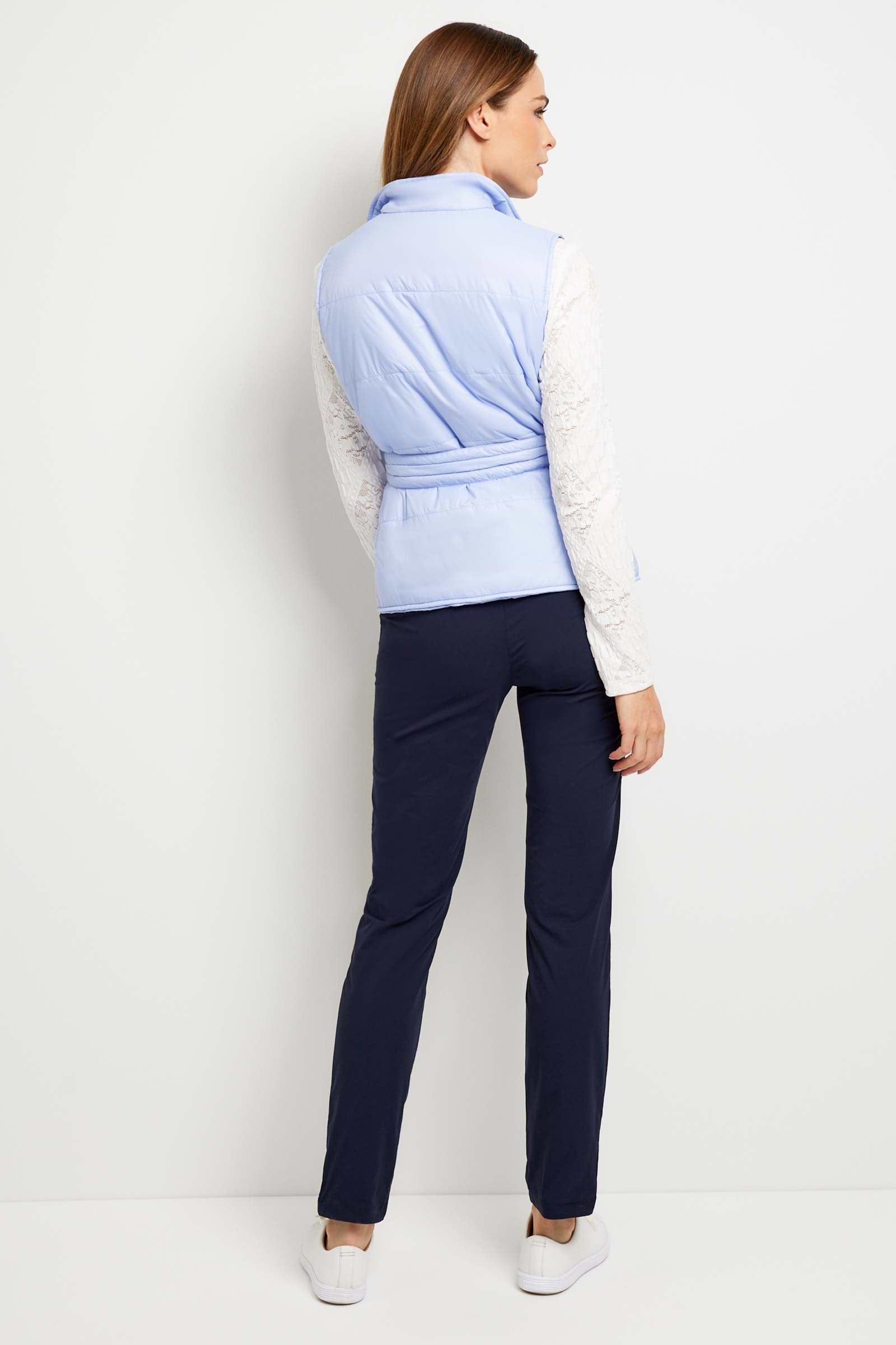 The Best Travel Vest. Woman Showing the Back Profile of an Ainslee Quilted Vest in Periwinkle