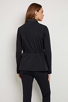 The Best Travel Jacket. Woman Showing the Back Profile of an Allegra Jacket in Black.