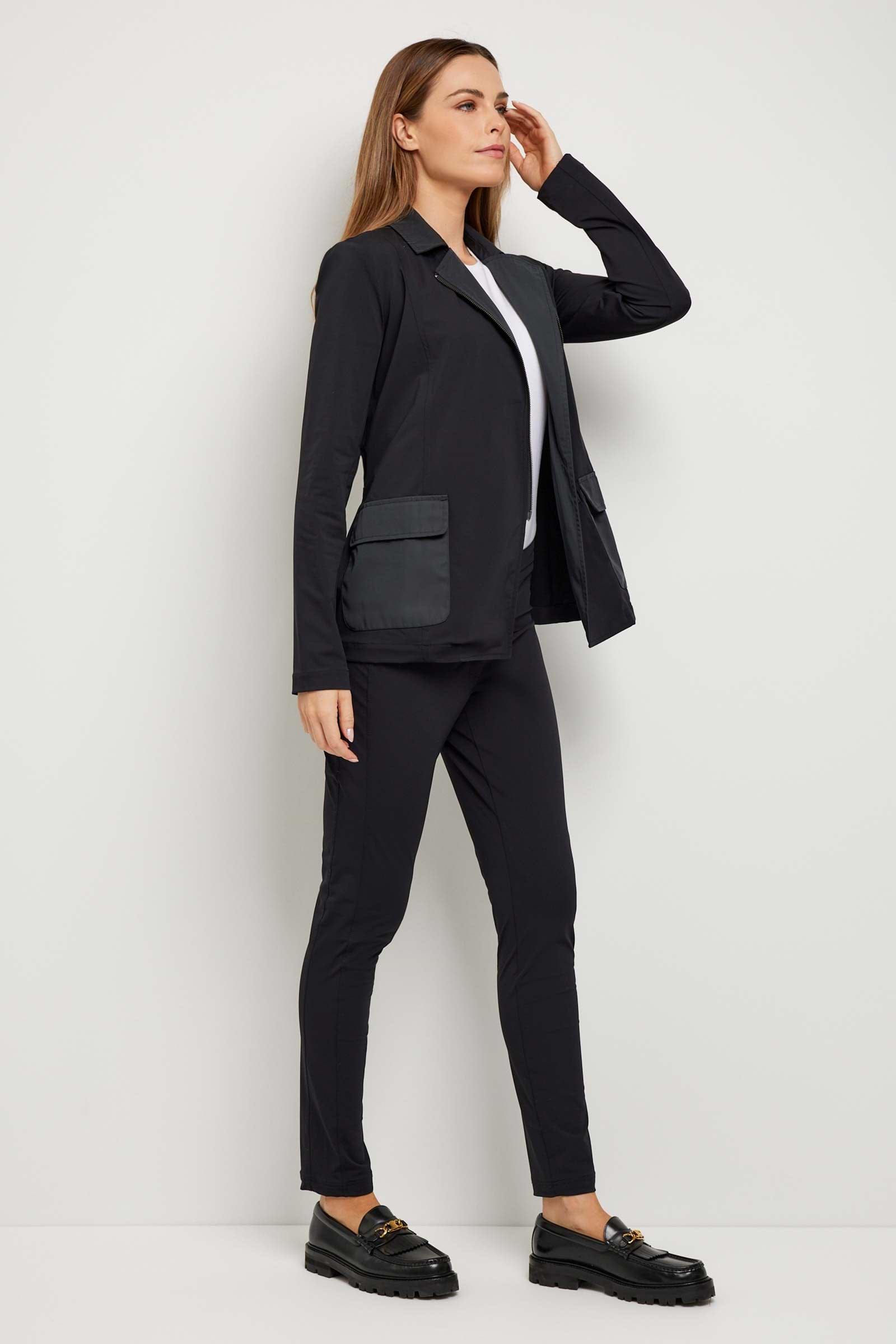 The Best Travel Jacket. Woman Showing the Side Profile of an Allegra Jacket in Black.
