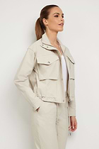 The Best Travel Jacket. Woman Showing the Side Profile of a Blaise Jacket in Champagne.