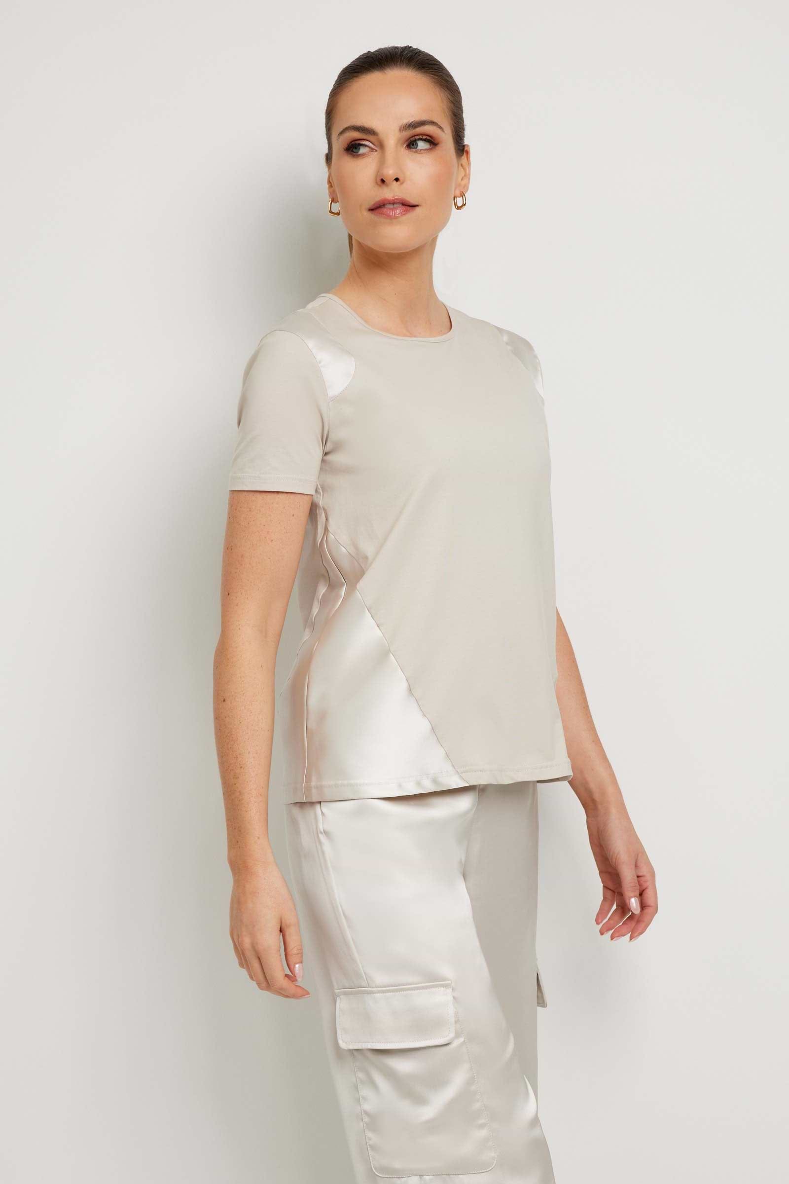 The Best Travel Top. Woman Showing the Side Profile of a Carmella Top in Stone.