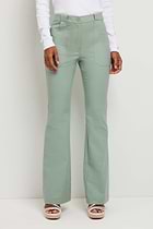 The Best Travel Pant. Woman Showing the Front Profile of a Darby Pant in Sage.