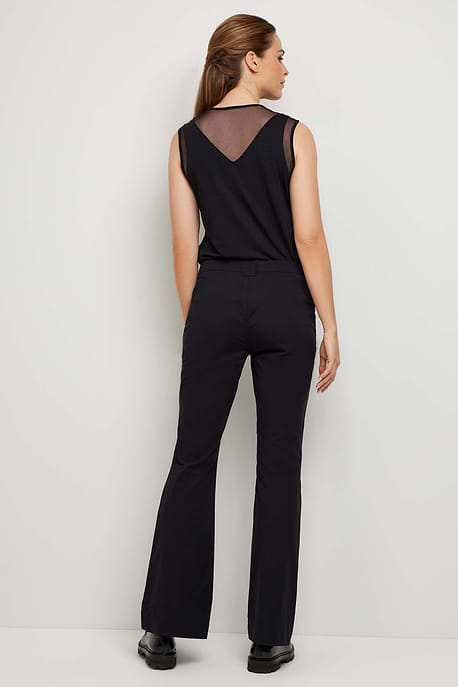The Best Travel Pant. Woman Showing the Back Profile of a Darby Pant in Black.