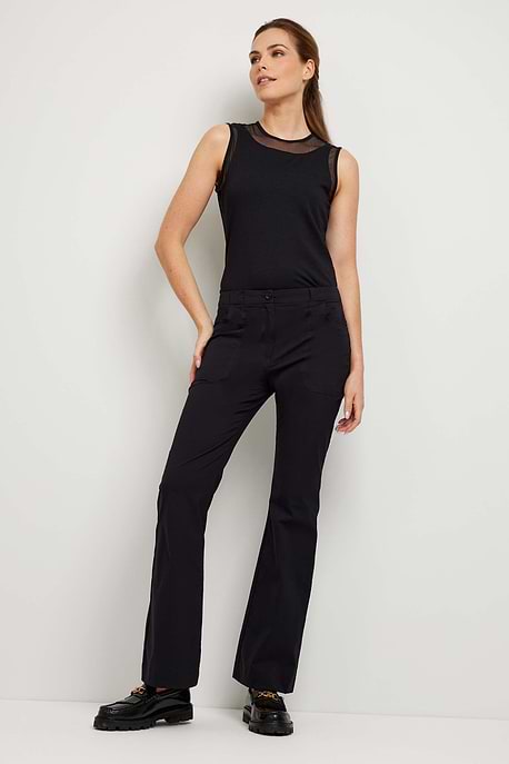 The Best Travel Pant. Woman Showing the Front Profile of a Darby Pant in Black.
