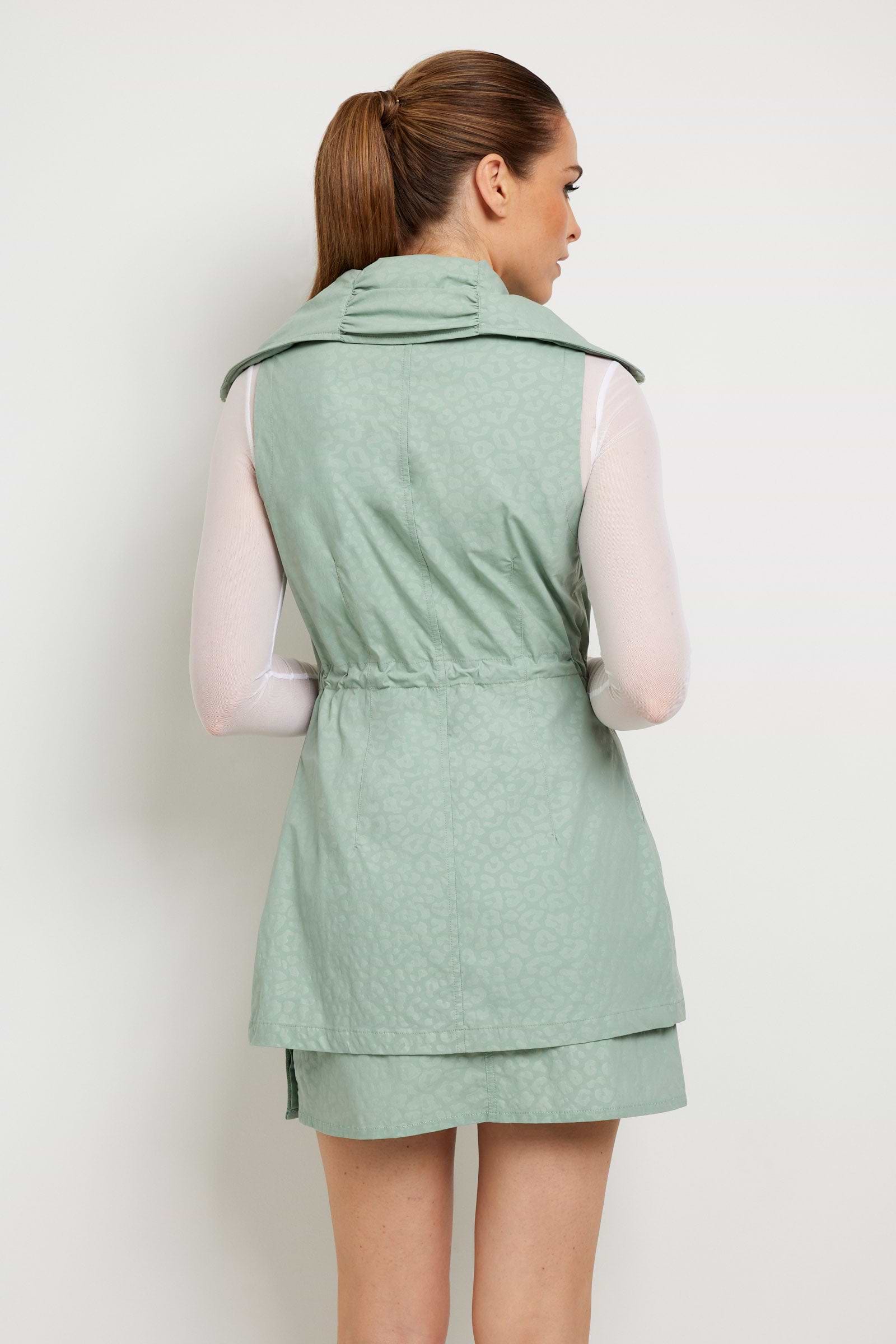 The Best Travel Vest. Woman Showing the Back Profile of an Embossed Delaney Vest in Cheetah Sage.