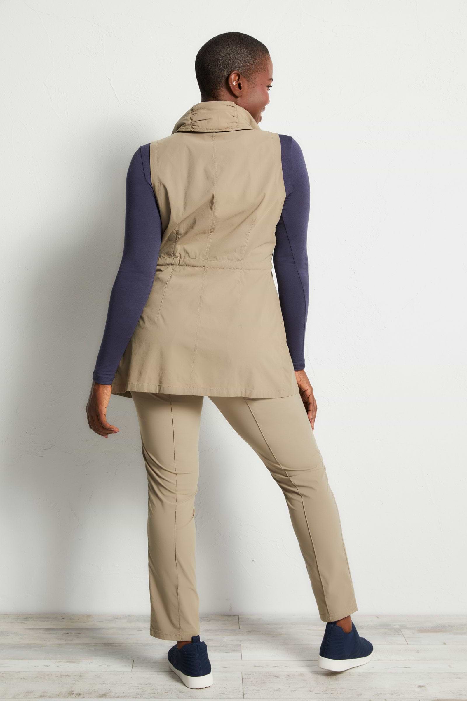 The Best Travel Vest. Woman Showing the Back Profile of a Delaney Travel Vest in Khaki
