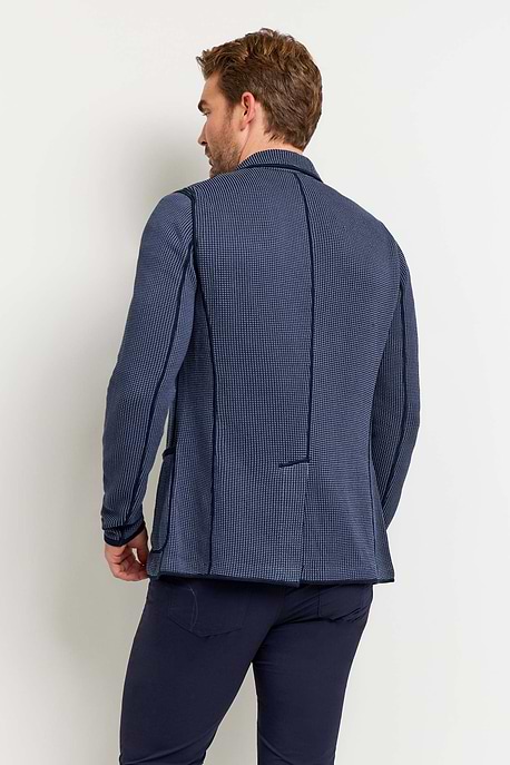 The Best Travel Jacket. Man Showing the Back Profile of a Men's Duncan Jacket in 2 Tone Blue.
