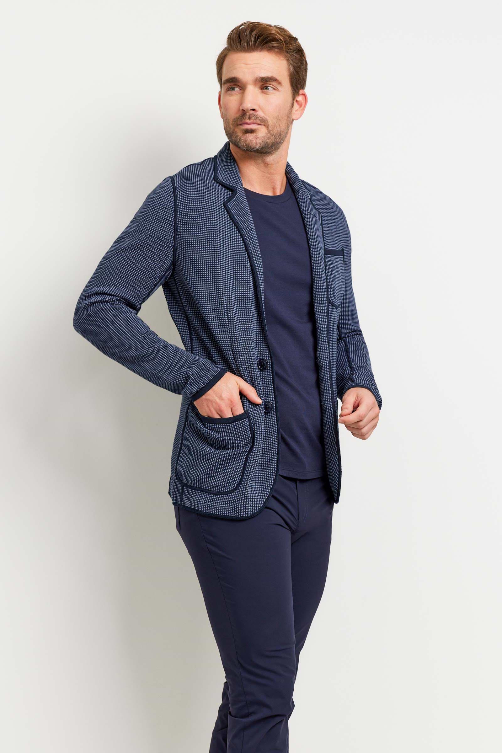 The Best Travel Jacket. Man Showing the Side Profile of a Men's Duncan Jacket in 2 Tone Blue.