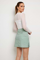The Best Travel Skirt. Woman Showing the Back Profile of an Embossed Suzzette Skort in Cheetah Sage.