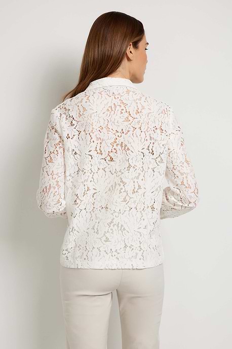 The Best Travel Top. Woman Showing the Back Profile of an Estella Stretch Lace Button Up Top in Off White.