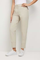 The Best Travel Pants. Woman Showing the Side Profile of a Gemma Pant in Champagne.