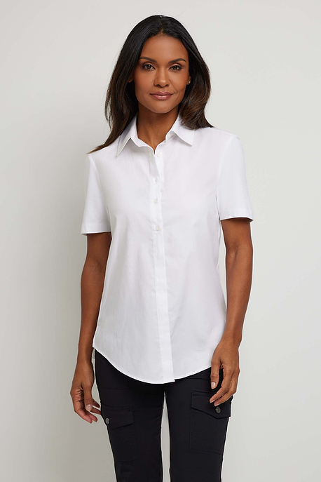 The Best Travel Top. Woman Showing the Front Profile of a Helia Top in White.
