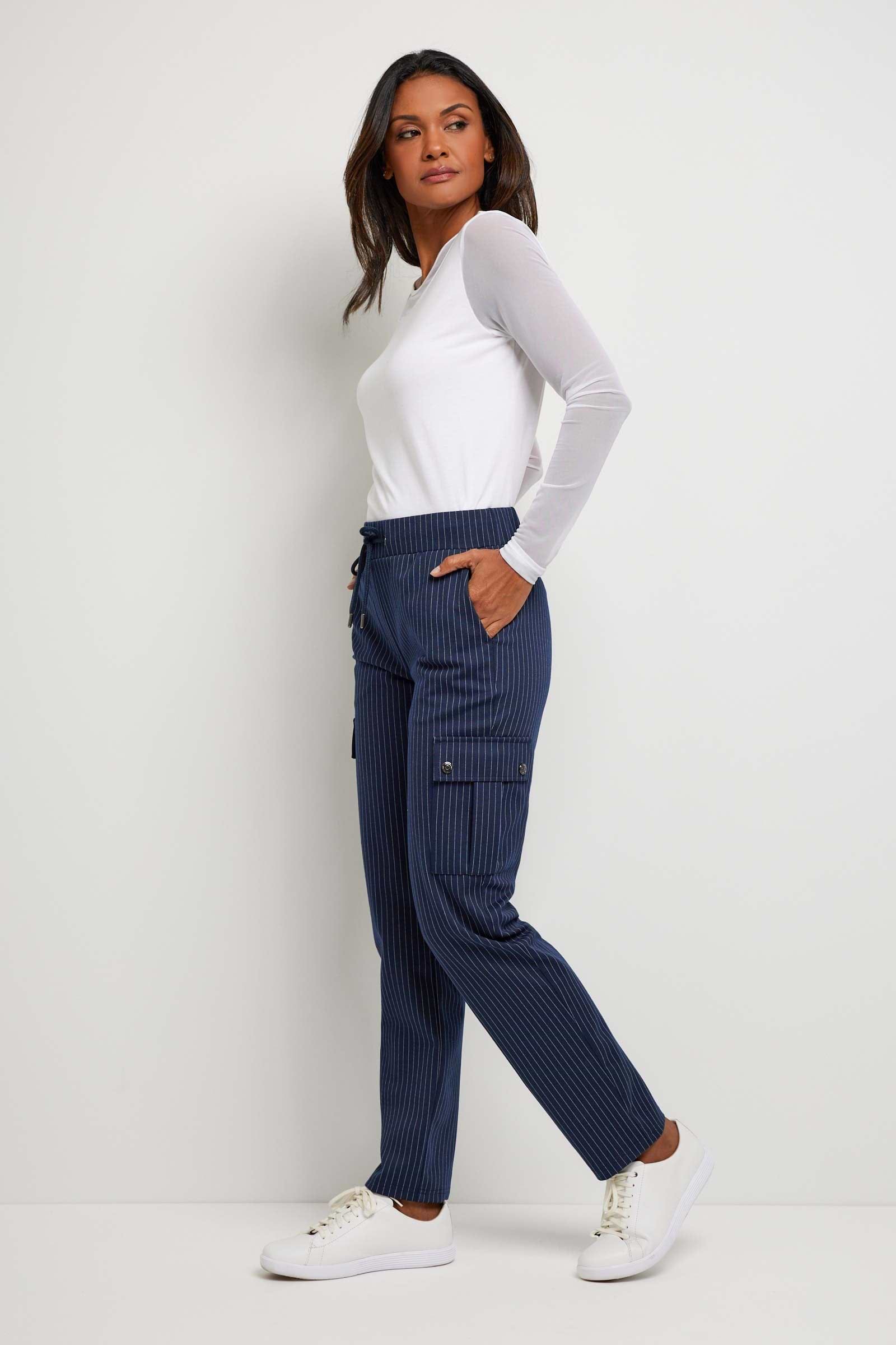 The Best Travel Pant. Woman Showing the Side Profile of an Indie Pant in Navy/White.
