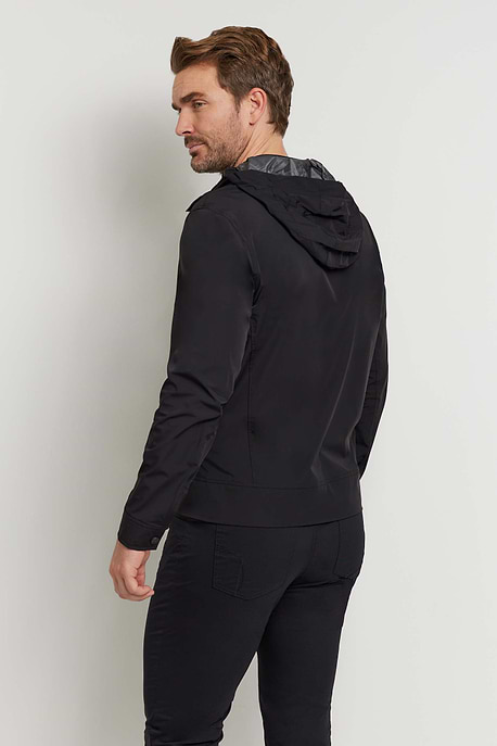 The Best Travel Jacket. Man Showing the Back Profile of a Men's Jack Zip Jacket in Black.
