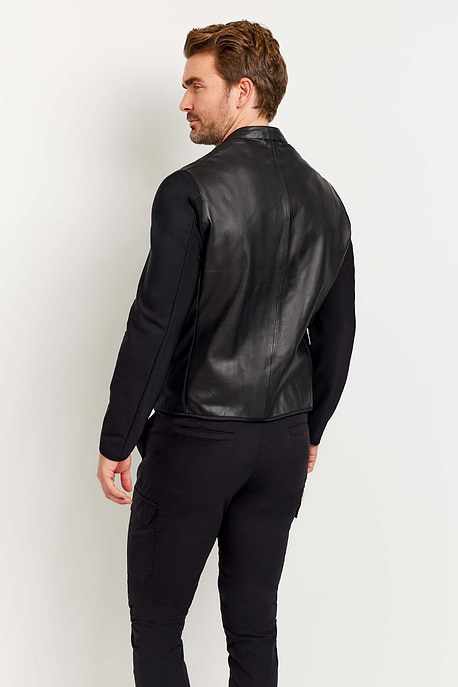 The Best Travel Jacket. Man Showing the Back Profile of a Men's Joey Leather Jacket in Black.
