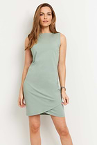 The Best Travel Dress. Woman Showing the Front Profile of a Johanna Dress in Sage.