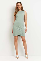 The Best Travel Dress. Woman Showing the Front Profile of a Johanna Dress in Sage.