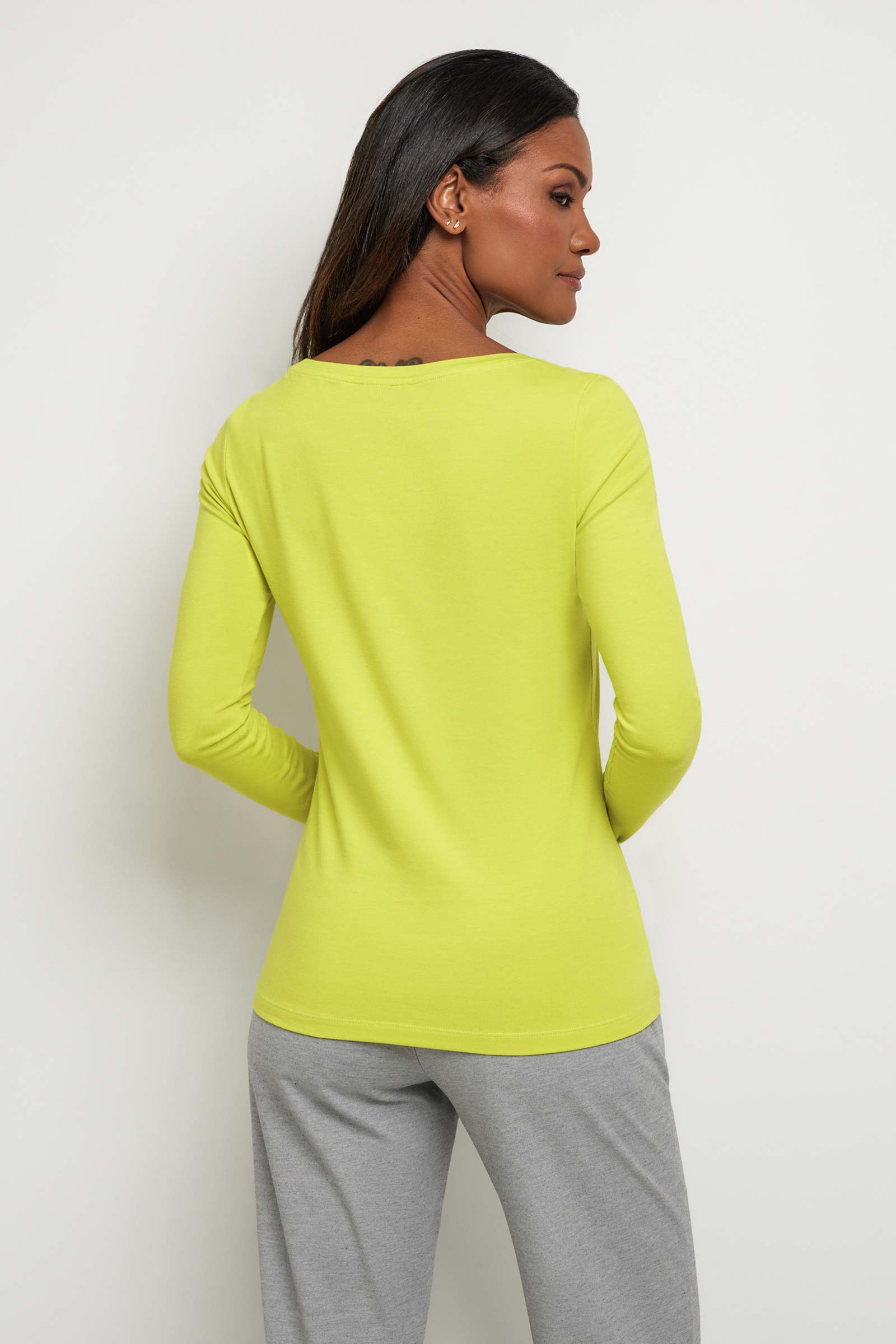 The Best Travel Top. Woman Showing the Back Profile of a Juliana Top in Citrus Yellow.