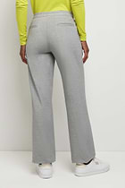 The Best Travel Pants. Woman Showing the Back Profile of a Kaia Pant in Light Heather Grey.