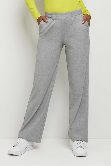 The Best Travel Pants. Woman Showing the Front Profile of a Kaia Pant in Light Heather Grey.